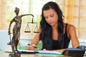 Scales of Justice Statue as female lawyer advocates against Tort Reform